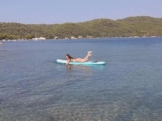 Nudist on paddleboard