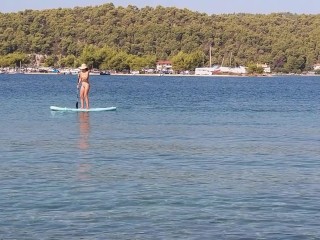 Nudist on paddleboard