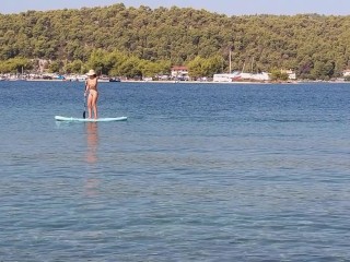 Nudist on paddleboard