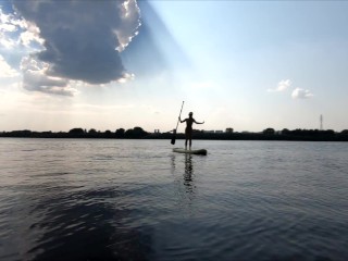 Naked Girl swims on sup board