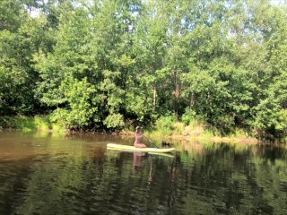 Naked teen on paddleboard