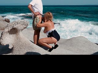Naughty MILF jerks off and sucks young guy in a secluded beach spot - Nudist Video