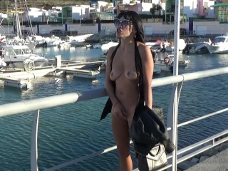 Hot blonde walks without panties and strips naked at the seaport - Nudist Video